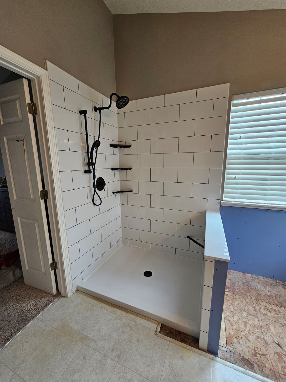 Wider view of the completed bathroom conversion showing the shower and vanity