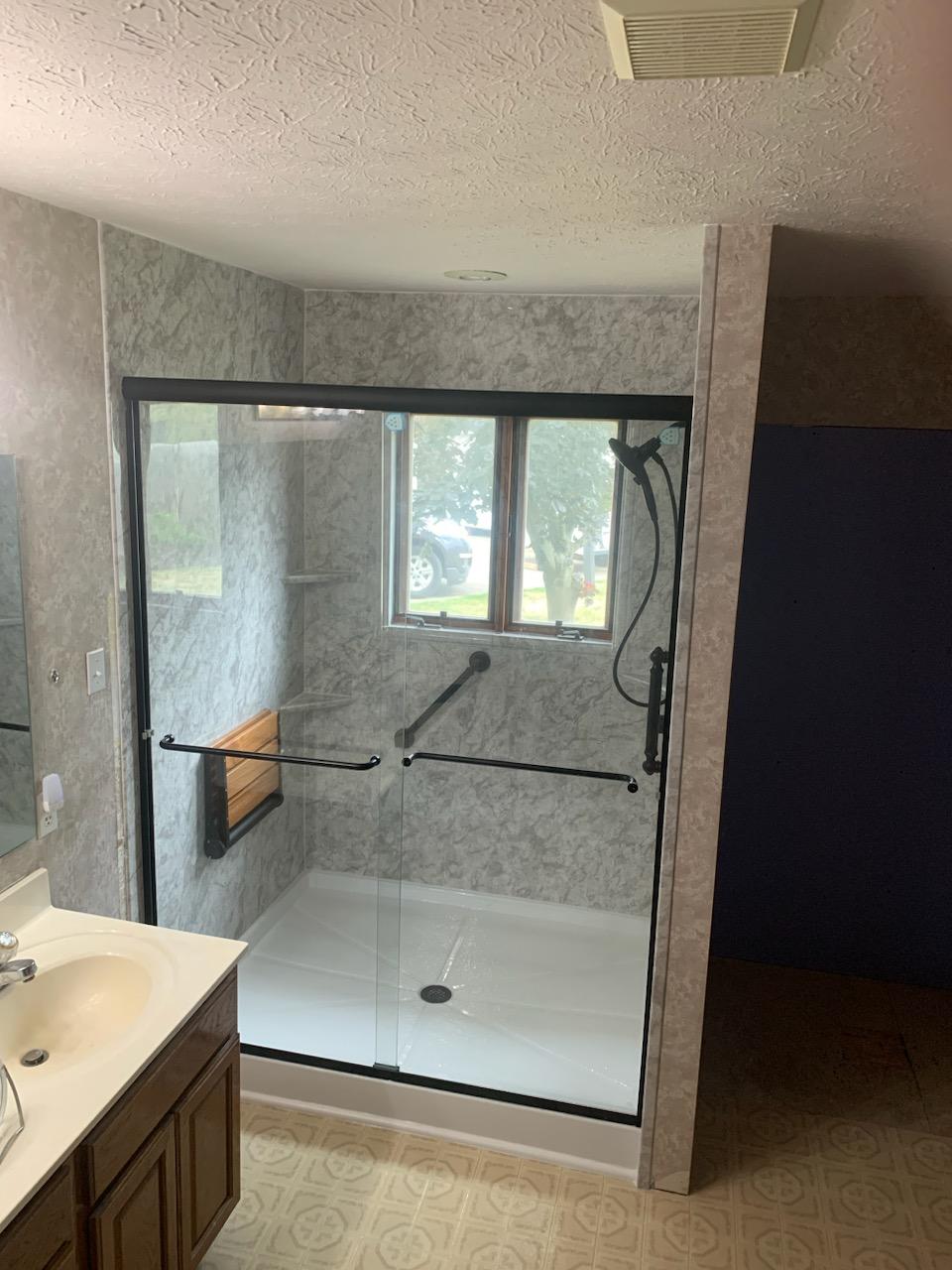 Remodeled bathroom with a new walk-in shower, vanity and fittings